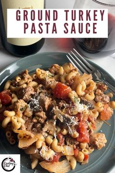 a plate with pasta and meat on it next to a glass of red wine that says ground turkey pasta sauce