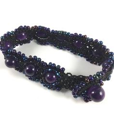 Amethyst Beads set in black macrame with Blue Iris beads Bohemian Amethyst Beaded Bracelets, Purple Bohemian Jewelry With Black Beads, Bohemian Purple Jewelry With Black Beads, Adjustable Amethyst Beads For Jewelry Making, Black Amethyst 8mm Bead Bracelets, Black Amethyst Bracelets With 8mm Beads, Black Amethyst Bracelet With 8mm Beads, Purple Beaded Bracelets With Black Beads As A Gift, Spiritual Purple Macrame Jewelry