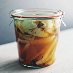 a glass jar filled with food sitting on top of a table