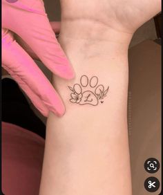 a dog paw tattoo on the wrist