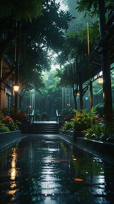 a rain soaked walkway leading into a lush green forest filled with trees and flowers at night