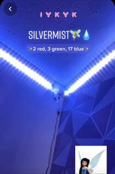 an advertisement for silvermistt is shown on the wall with blue lights and a woman standing in front of it