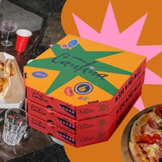 two pizzas are sitting in boxes on the table next to some drinks and glasses