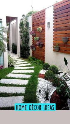 an outdoor garden with grass and stepping stones