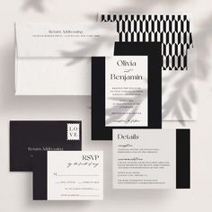 the black and white wedding suite is displayed with matching envelopes, rsp cards, and