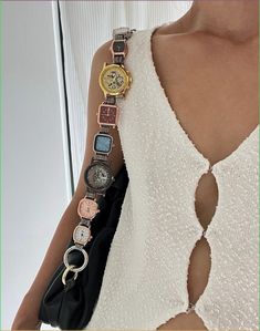 a woman with many watches on her arm