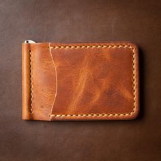 A Slim Leather Wallet that's Built for Cash and Cards. This wallet securely holds bills and cards while maintaining a slim profile, perfect for front-pocket carry. Quickly flip through your cash without having to remove your entire stack of bills. The solid brass spring bar clip ensures your money is secure and stays in your pocket.Our full-grain Horween leather means your wallet will develop character and patina. We hand-sew this wallet with thick Tiger Thread so it will never unravel or come a