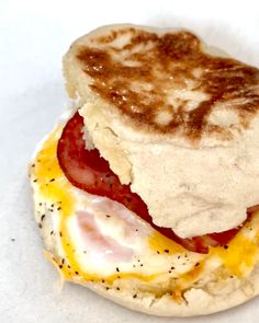 an english muffin with bacon and eggs on it