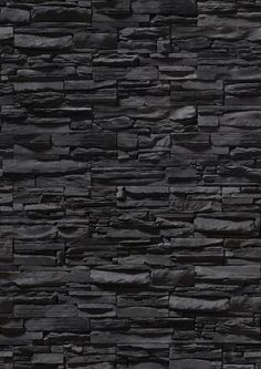 a black stone wall textured with dark gray bricks