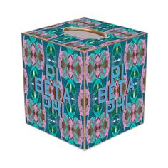 a blue box with pink and green designs on the lid that says delta pha