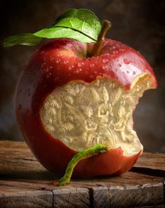 an apple that has been carved to look like a piece of fruit with leaves on it