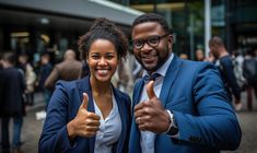 a man and woman giving thumbs up in front of a building with people walking around