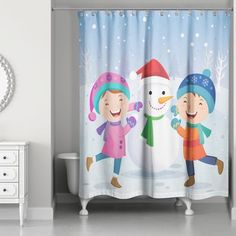 a shower curtain with two children playing in the snow