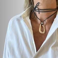 This super chic cord choker has an abstract charm made of shell like resin.  It will uplift your summer look whether for daytime or night occasions. The dark grey cord is extra long (170cm) so that it can be worn as a choker or a long necklace, as you prefer. Being made of super soft suede cord and a lightweight pendant, it is very comfortable to wear. Pendant size: 2.5cm/1"(W) x 4cm/1.6"(H) Suede Cord Necklace, Cord Choker, Necklace Shell, Abstract Jewelry, Tie Necklace, Wrap Necklace, Necklace Cord, Wrap Necklaces, Suede Cord