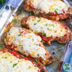 baked chicken parmesan in a baking pan with cheese and herbs on top, ready to be eaten