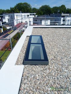 the roof of a building with gravel and rocks on it's sides is shown