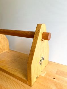 a wooden bench sitting on top of a hard wood floor