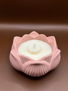 a pink candle holder sitting on top of a table