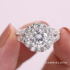 a close up of a person holding a diamond ring