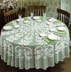 the table is set with white plates and green napkins on it's lace doily