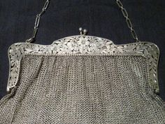 Wonderful Vintage Sterling Mesh purse with Hand cut-out pierce floral open work handle by  Ernst Gideon Bek, Inc.,15 Maiden Lane, New York.. Circa 1890's to 1910. it is marked Sterling and has a butterfly for the markers mark I will try to add the maker later if I find out who it was. It's weight is approximately 212.8 grams. The purse is approximately 6.25" wide across the handle by 5.75" tall from the handle down without counting the chain. The sterling chain is about 16" long. It is in Great Victorian Purses, Mesh Bags, Couture Bags, Vintage Purses, The Maker, Beaded Bags, Mesh Bag, A Butterfly, Michael Kors Monogram