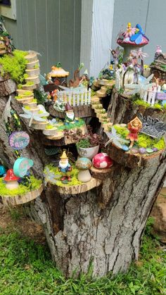 a tree stump with fairy houses on it