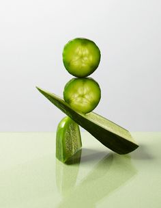 two slices of cucumber stacked on top of each other in front of a white background