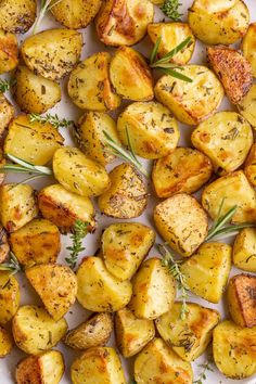 roasted potatoes with herbs and seasoning on a white plate