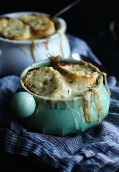 two bowls filled with food sitting on top of a blue cloth next to each other