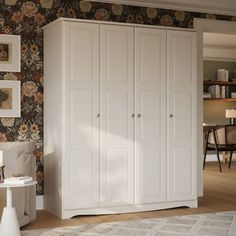 a white wardrobe in a room with floral wallpaper