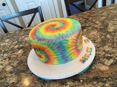 a tie - dyed cake sitting on top of a counter