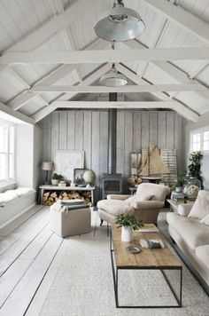 a living room filled with white furniture and lots of windows