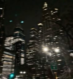 the city is lit up at night with street lights and skyscrapers in the background