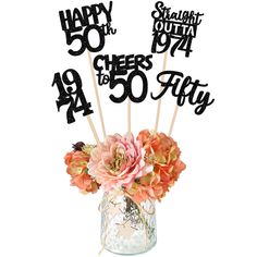 a bouquet of flowers in a vase with happy 50th birthday cake toppers on sticks