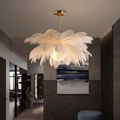 an elegant chandelier hangs from the ceiling in this modern living room with black marble walls and flooring