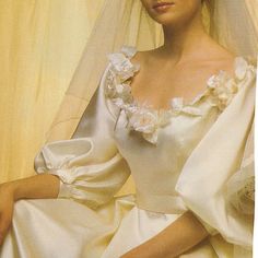 a woman wearing a wedding dress and veil