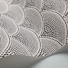 an intricately designed tablecloth with black dots on it