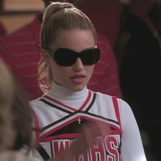 a woman wearing sunglasses and a cheerleader shirt in the movie meanie girl 2000