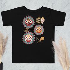 Celebrate divine love with our adorable Jagannath, Baladeva, Subhadra, and Sudarshan T-shirt! 🌸✨  Ideal for temple, festivals, kirtans, or daily wear. Carry the blessings of Jagannath, Baladeva, Subhadra, and Sudarshan with you always. Get yours today and spread the divine joy!  Jaiii!!  Material: * 100% combed and ring-spun cotton * Fabric weight: 4.2 oz/yd² (142 g/m²) * Relaxed fit for extra comfort * Side-seamed construction * Pre-shrunk fabric * Blank product sourced from the US or Honduras Traditional Crew Neck Top For Festivals, Cotton Short Sleeve Tops For Diwali, Cotton Tops For Puja And Navratri Festival, Cotton Tops For Navratri Puja, Cotton Tops For Puja And Navratri, Cotton Tops For Puja During Diwali, Cotton Tops For Diwali Puja, Cotton Tops For Puja And Diwali, Cotton Tops For Puja And Festivals