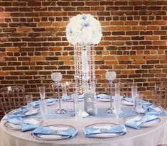 the table is set with blue and white flowers