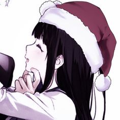 a girl with long hair wearing a santa hat and holding a cell phone to her ear