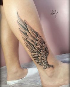 a woman's leg with an eagle tattoo on it