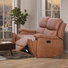 a living room with a brown recliner and a coffee table in front of a large window