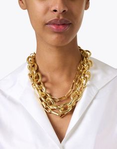 Make a statement in this luxe chain necklace from Kenneth Jay Lane. Featuring three different shapes and sizes of chain, layering has never been easier. Add sparkle and drama to your everyday look by pairing this necklace with a crisp white shirt and more chunky gold jewelry. Chic Gold-plated Double Chain Necklace, Chic Gold-plated Layered Chain Necklace, Chic Gold Plated Double Chain Necklace, Chunky Chain Metal Necklace For Layering, Gold-tone Chic Cable Chain Necklaces, Chic Gold-tone Cable Chain Necklaces, Chic Gold-tone Necklace With Cable Chain, Modern Gold Chain Necklace For Layering, Chic Gold Layered Necklace With Chunky Chain