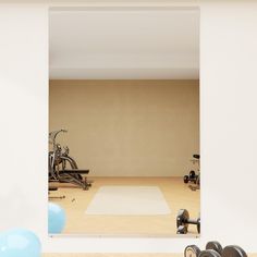 there is a gym with exercise equipment in the room and blue balls on the floor