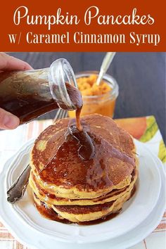 a stack of pumpkin pancakes with caramel syrup being drizzled on top