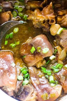 a pot filled with meat and vegetables on top of a stove