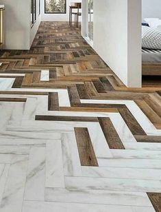 a long hallway with wood flooring and white walls