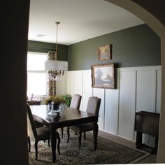 a dining room table with chairs and a chandelier hanging from it's ceiling