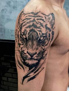 a man with a tiger tattoo on his arm